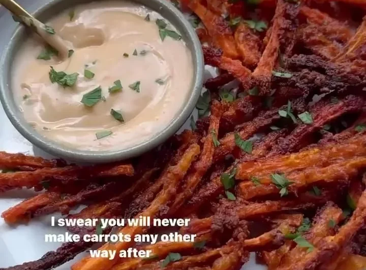 Baked crispy carrot fries served in a bowl with dipping sauce