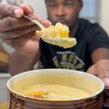 Delicious bowl of loaded potato soup topped with bacon, cheese, and scallions.