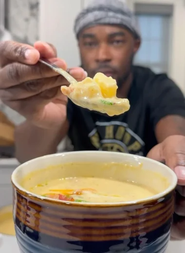 Delicious bowl of loaded potato soup topped with bacon, cheese, and scallions.
