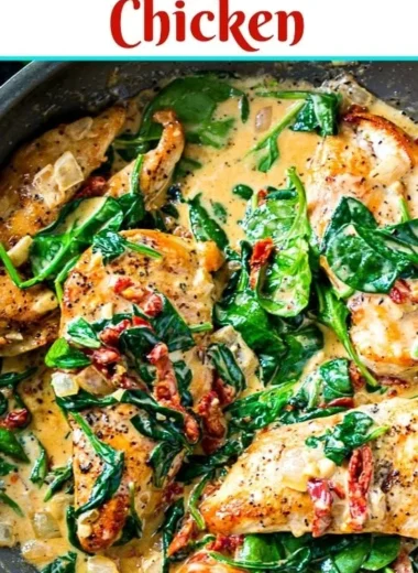 Creamy Tuscan chicken dish with herbs and vegetables in a bowl.