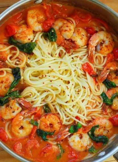 Shrimp pasta dish featuring garlic basil tomato sauce in a bowl