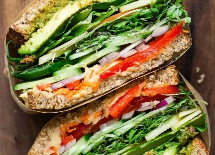 Colorful veggie sandwich loaded with fresh vegetables and healthy ingredients.