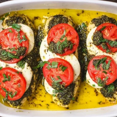 Basil pesto tomato mozzarella chicken bake served on a plate