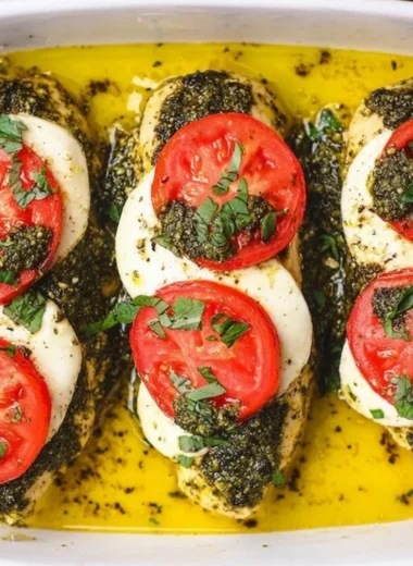 Basil pesto tomato mozzarella chicken bake served on a plate