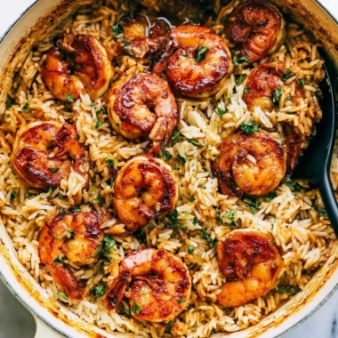 Cajun shrimp served over rice garnished with herbs
