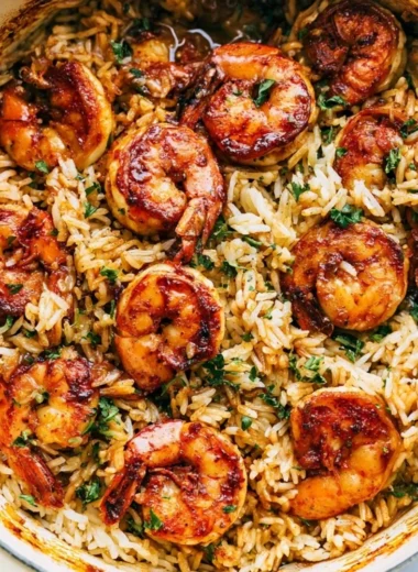 Cajun shrimp served over rice garnished with herbs