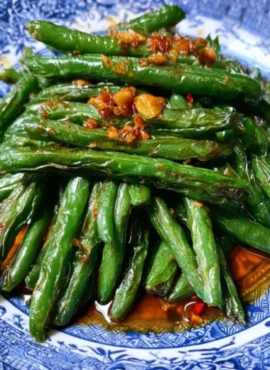 Chinese green beans stir fry served in a bowl with garlic and sesame seeds