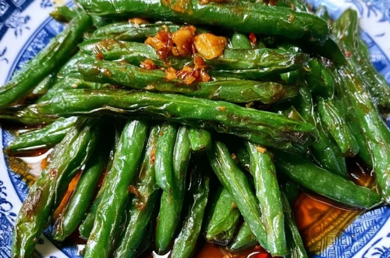 Chinese green beans stir fry served in a bowl with garlic and sesame seeds