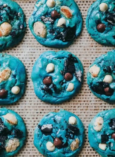 Freshly baked Cookie Monster cookies with chocolate chips and colorful sprinkles