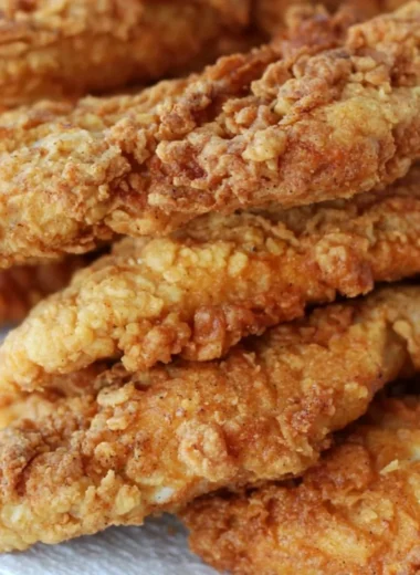 Plate of crispy chicken tenders served with dipping sauce