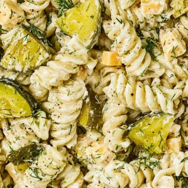 Bowl of Dill Pickle Pasta Salad with fresh vegetables and dressing