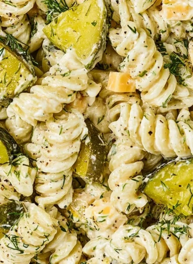 Bowl of Dill Pickle Pasta Salad with fresh vegetables and dressing