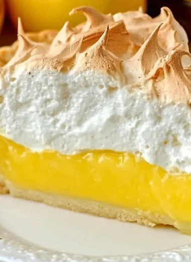 Homemade lemon meringue pie topped with fluffy meringue and lemon filling