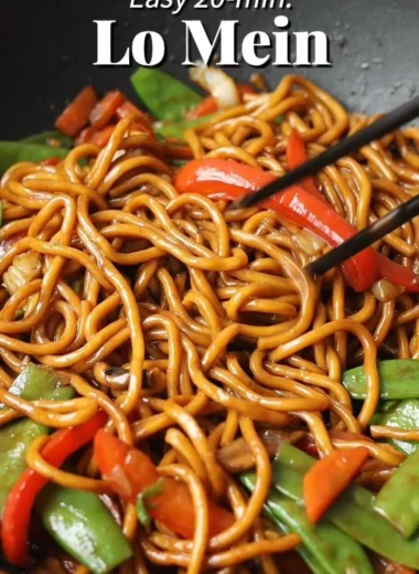 Delicious bowl of Lo Mein noodles topped with fresh vegetables and savory sauce