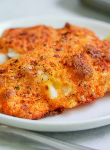 Delicious Parmesan Crusted Cod served with lemon garnish on a plate