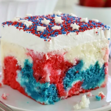 Patriotic poke cake with red, white, and blue layers for 4th of July celebration