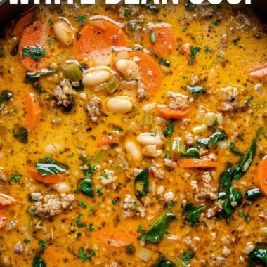 Bowl of Tuscan white bean soup garnished with herbs