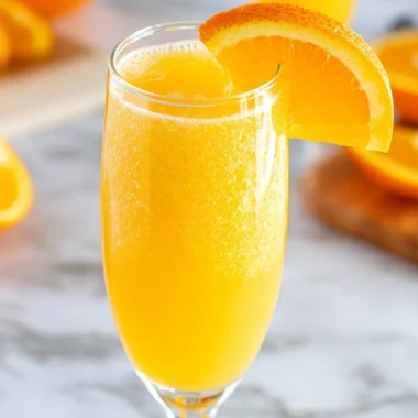 Refreshing non-alcoholic mimosa served in a glass with citrus fruits
