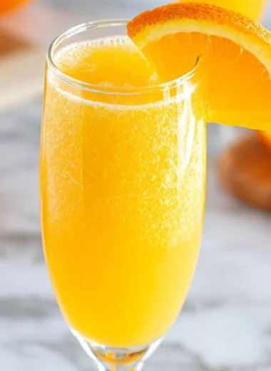 Refreshing non-alcoholic mimosa served in a glass with citrus fruits