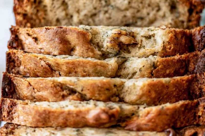 Delicious slice of easy banana bread on a wooden table