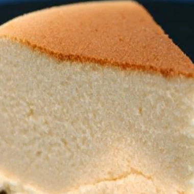 Fluffy Instant Pot Japanese cheesecake slice on a plate with berries