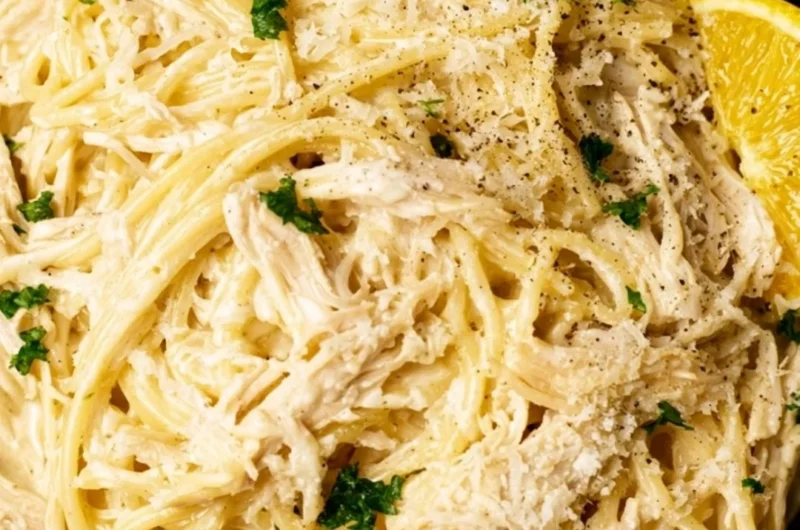 Creamy lemon chicken pasta with fresh herbs and lemon slices