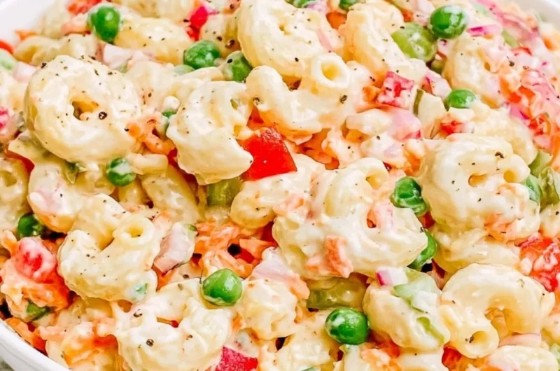 Delicious creamy macaroni salad served in a bowl with fresh herbs.