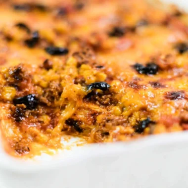 Easy taco bake with layers of cheese, ground beef and salsa in a baking dish.