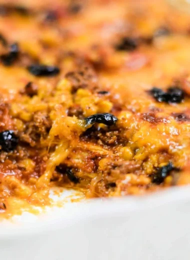 Easy taco bake with layers of cheese, ground beef and salsa in a baking dish.
