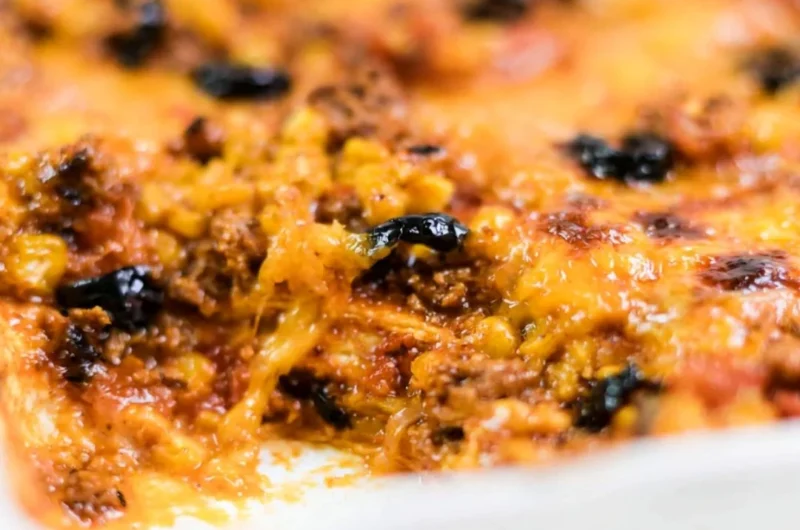 Easy taco bake with layers of cheese, ground beef and salsa in a baking dish.