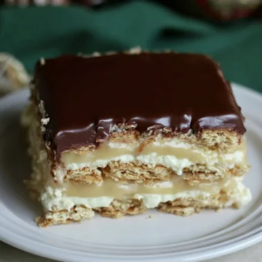 Delicious Eclair Icebox Cake with layers of cream and chocolate frosting