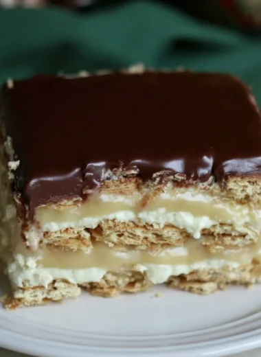 Delicious Eclair Icebox Cake with layers of cream and chocolate frosting