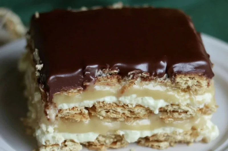 Delicious Eclair Icebox Cake with layers of cream and chocolate frosting