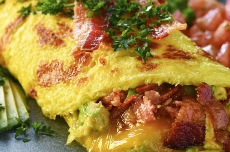 Keto avocado and bacon stuffed omelette with fresh ingredients