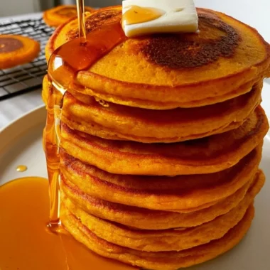Delicious cozy pumpkin cottage cheese pancakes stacked on a plate