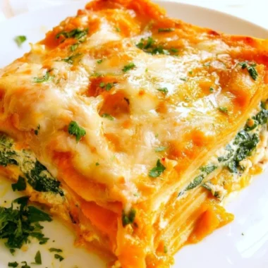 Cozy vegetarian pumpkin spinach lasagna with layers of cheese and herbs