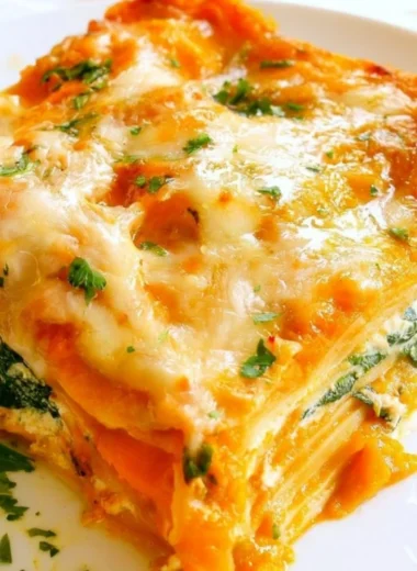 Cozy vegetarian pumpkin spinach lasagna with layers of cheese and herbs
