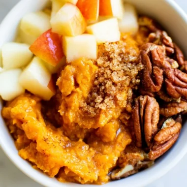 Sweet potato breakfast bowl with pecans and apples for a healthy meal.